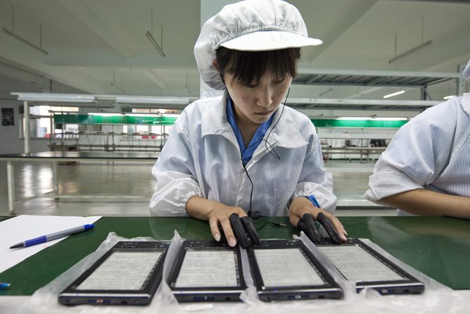 Chinese worker assembling electronic devices